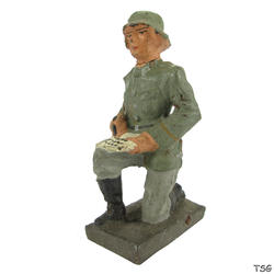 Lineol Signals soldier kneeling, writing