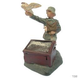Lineol Signals soldier kneeling, with carrier pigeon