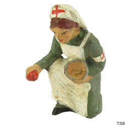 Elastolin Nurse kneeling, bandaging