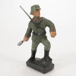 Soldier standing, throwing hand grenade