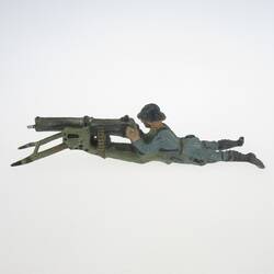 Soldier lying, shooting with heavy MG